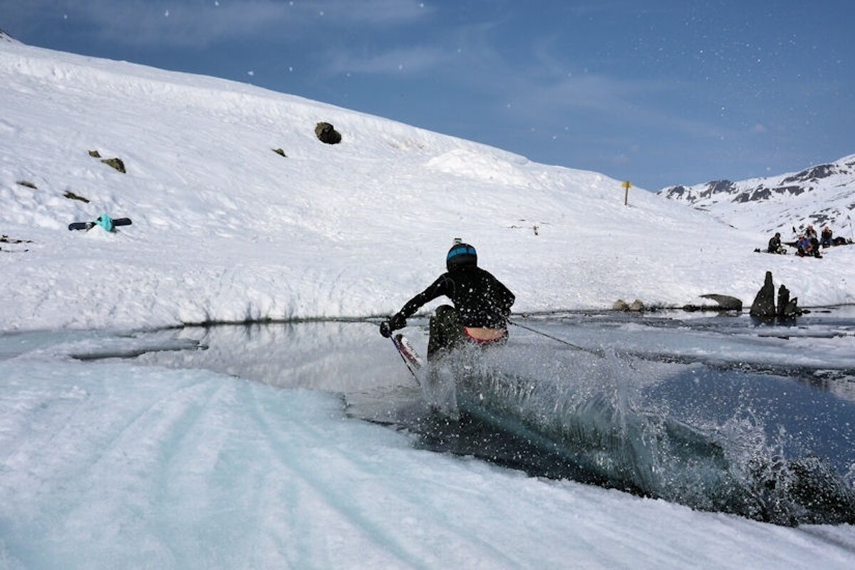 a skier going over a trough filled with water