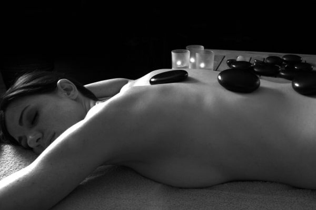 a woman having a hot stone massage